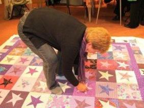 Gill sandwiching her quilt